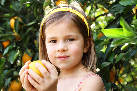 Girl Picking Oranges